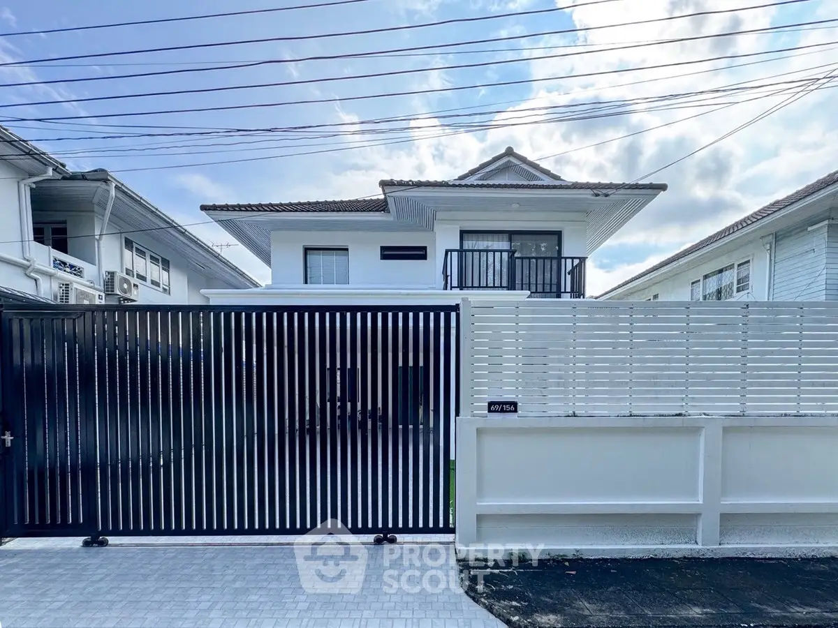Modern two-story house with gated entrance and sleek design