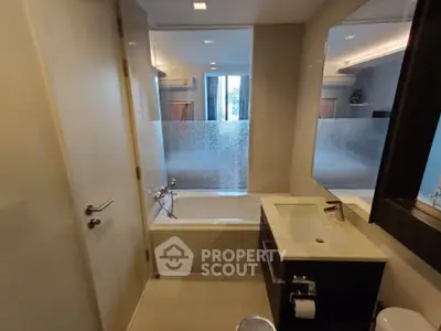 Modern bathroom with sleek design and frosted glass window