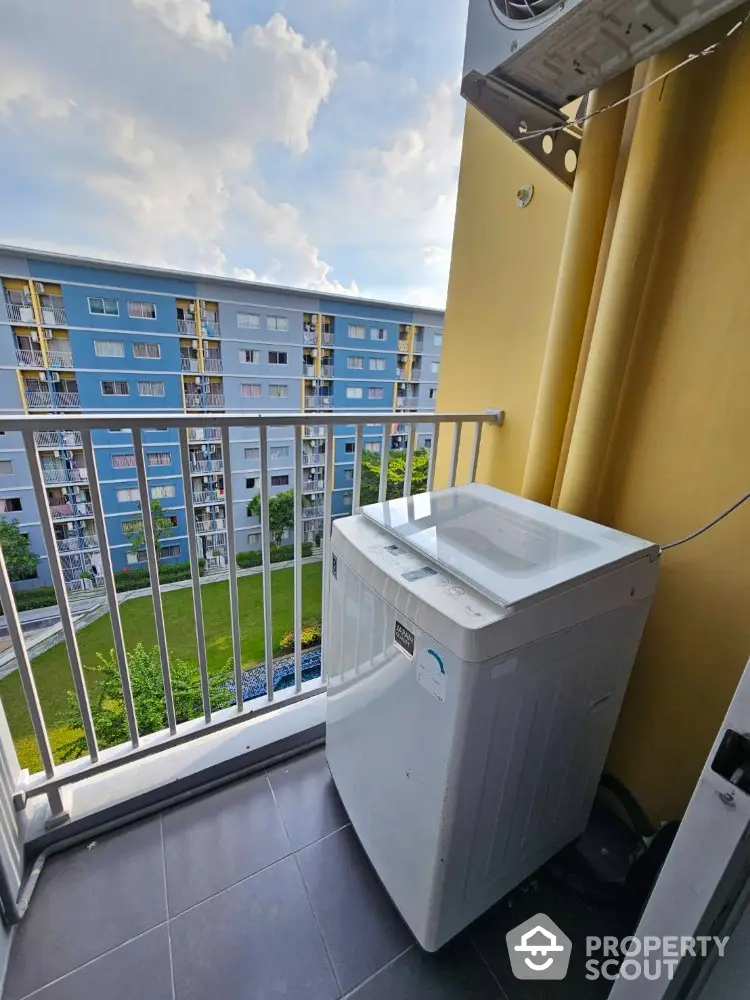 Charming balcony with washing machine and scenic view of residential building