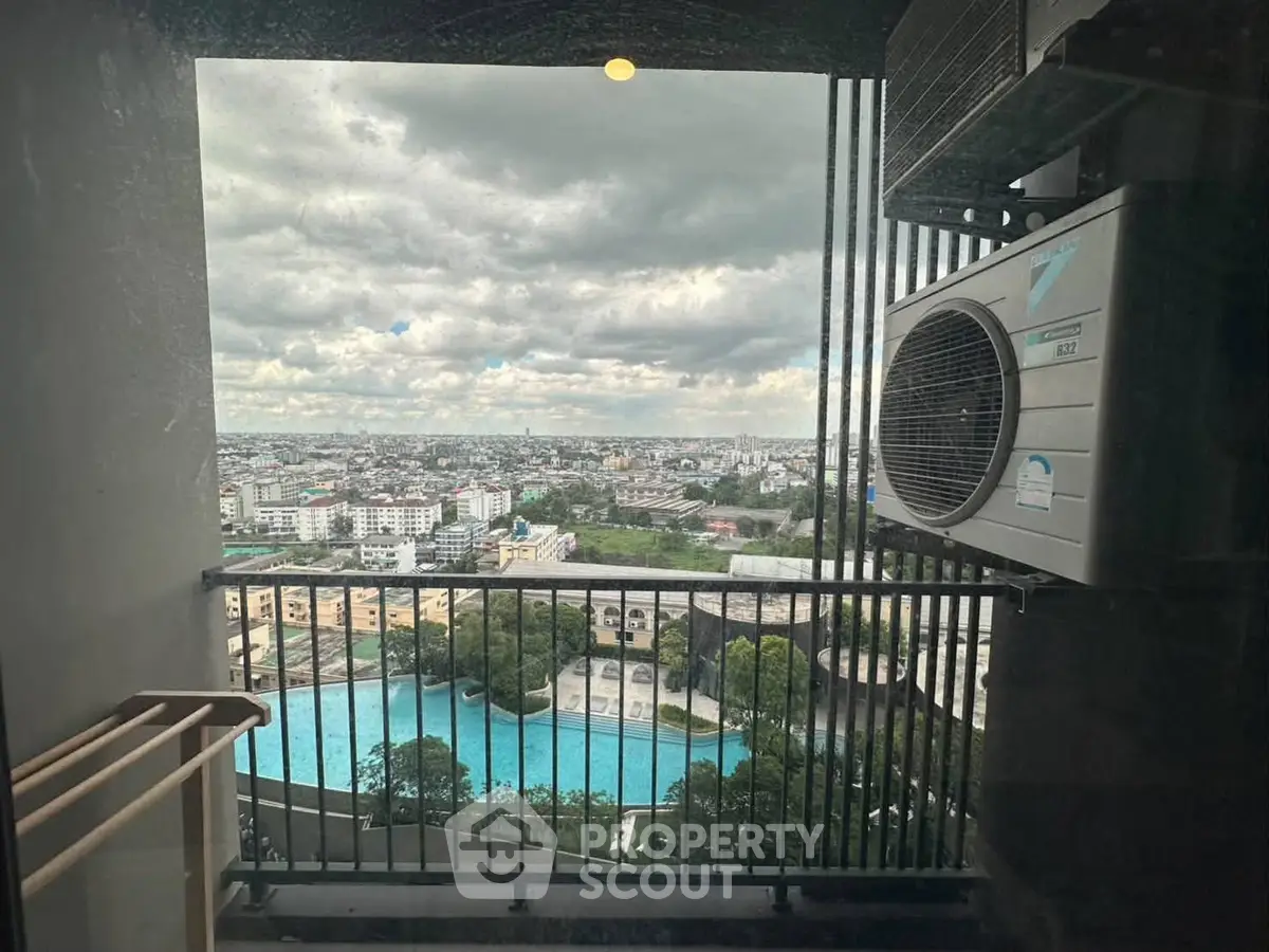 Stunning cityscape view from a high-rise balcony with pool and skyline.