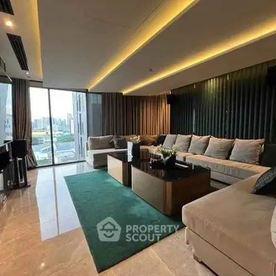 Luxurious living room with modern decor and city view, featuring plush seating and elegant lighting.