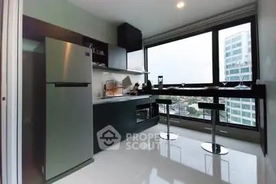 Modern kitchen with sleek appliances and city view