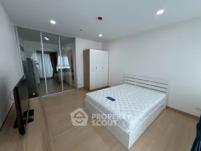 Spacious modern bedroom with minimalist design and ample natural light