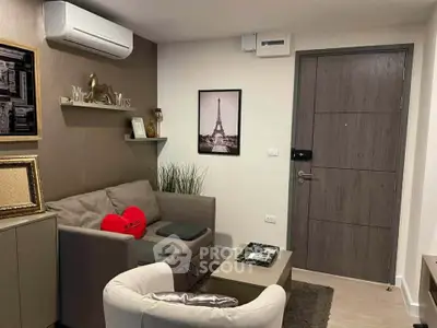 Cozy living room with modern decor and air conditioning, featuring a stylish sofa and elegant wall art.