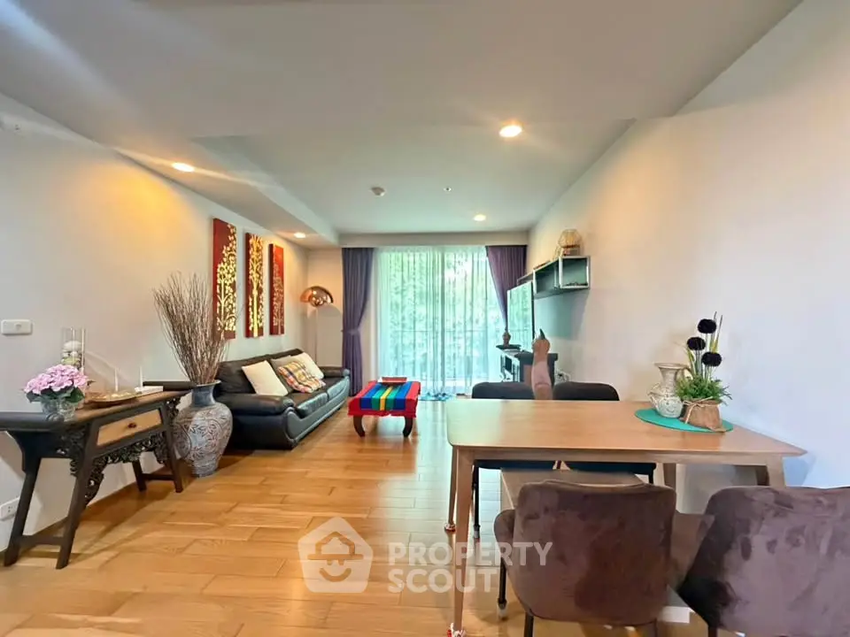 Spacious living room with modern decor and large window view