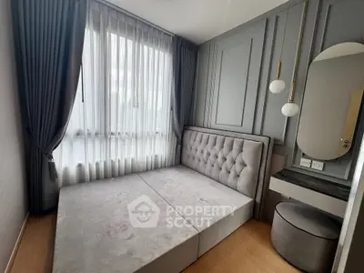 Modern bedroom with elegant gray decor and large window offering city views.