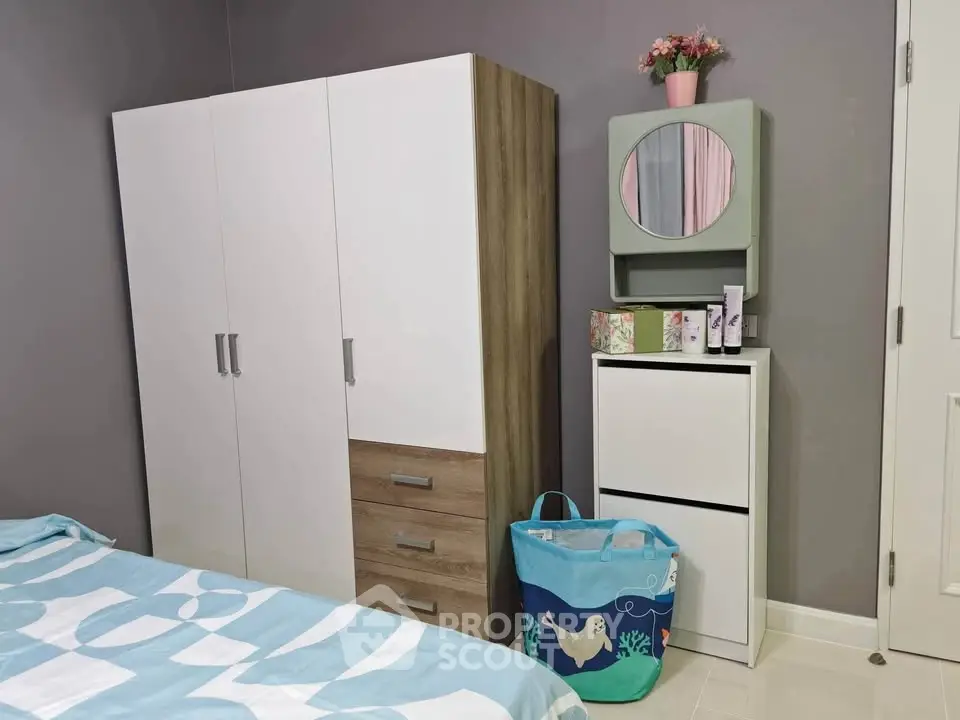Cozy bedroom with modern wardrobe and stylish decor, perfect for comfortable living.