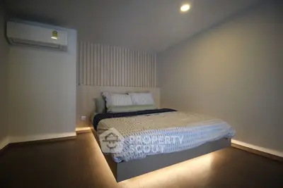 Modern minimalist bedroom with ambient lighting and air conditioning