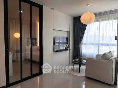 Modern living room with sleek design and large windows offering a scenic view.