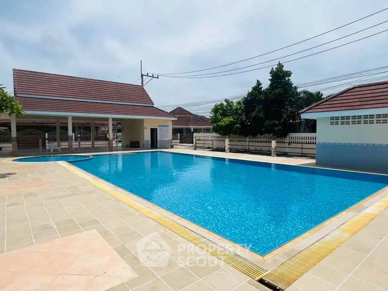 Stunning residential pool area with clear blue water and spacious deck.