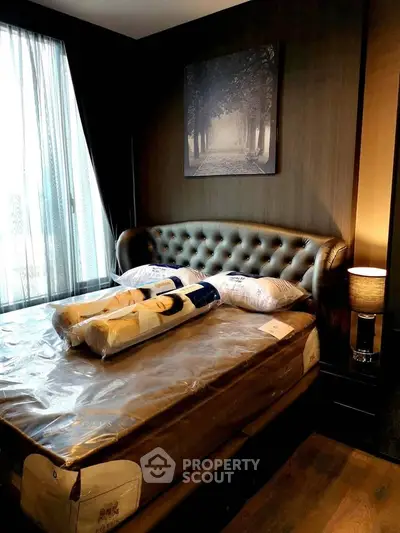 Luxurious bedroom with elegant decor and plush bedding in modern apartment.
