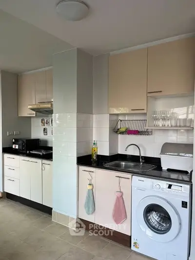 Modern kitchen with washing machine and sleek cabinetry
