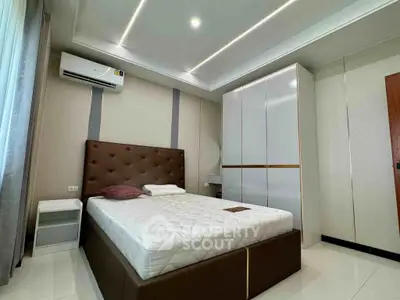 Modern bedroom with sleek design, featuring a comfortable bed, stylish wardrobe, and ambient lighting.