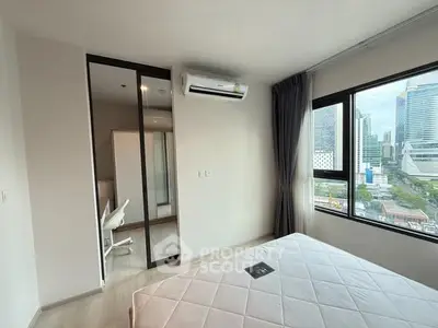 Modern bedroom with city view and air conditioning in high-rise apartment