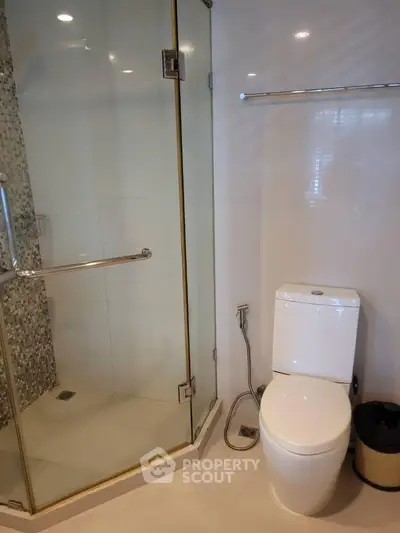 Modern bathroom with glass shower and sleek toilet design