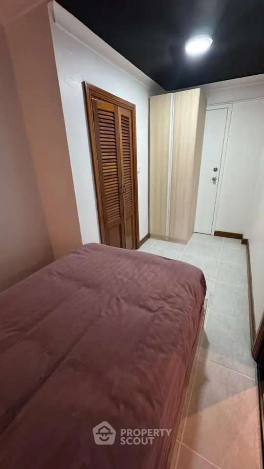 Cozy bedroom with wooden closet and modern lighting