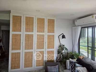 Stylish living room with woven cabinet and balcony view