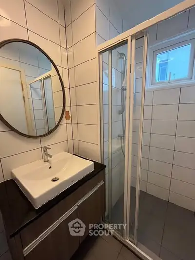 Modern bathroom with sleek sink and glass shower enclosure