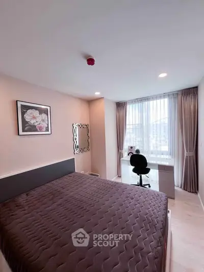Modern bedroom with large window and study desk, perfect for natural light lovers.