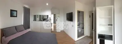 Spacious bedroom with modern decor and ensuite bathroom in stylish apartment