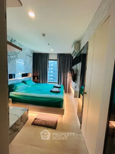 Modern bedroom with stylish decor and city view, featuring a comfortable bed and sleek furnishings.