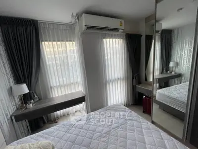 Cozy bedroom with modern decor and large windows for natural light