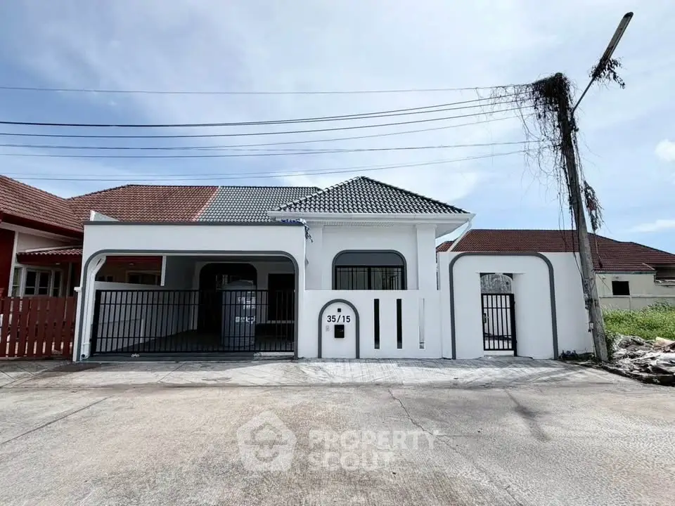 Charming single-story house with gated driveway and modern design in a serene neighborhood.