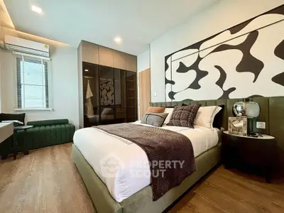 Luxurious bedroom with modern decor and large window for natural light
