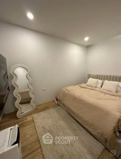 Cozy bedroom with modern decor and stylish mirror