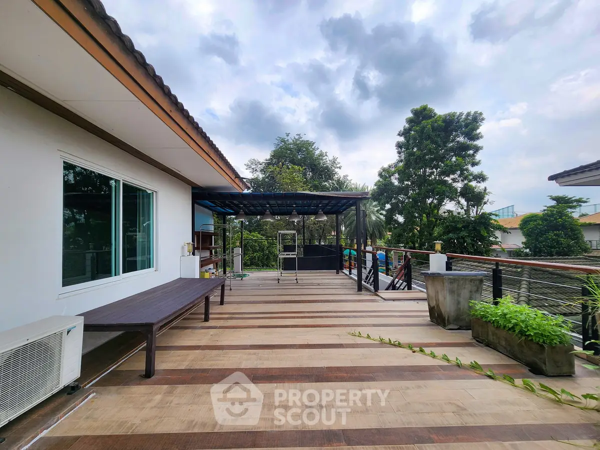 Spacious rooftop terrace with modern design and lush greenery