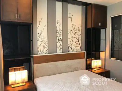 Elegant bedroom with a large bed, stylish headboard, and artistic wardrobe doors, complemented by warm bedside lighting.