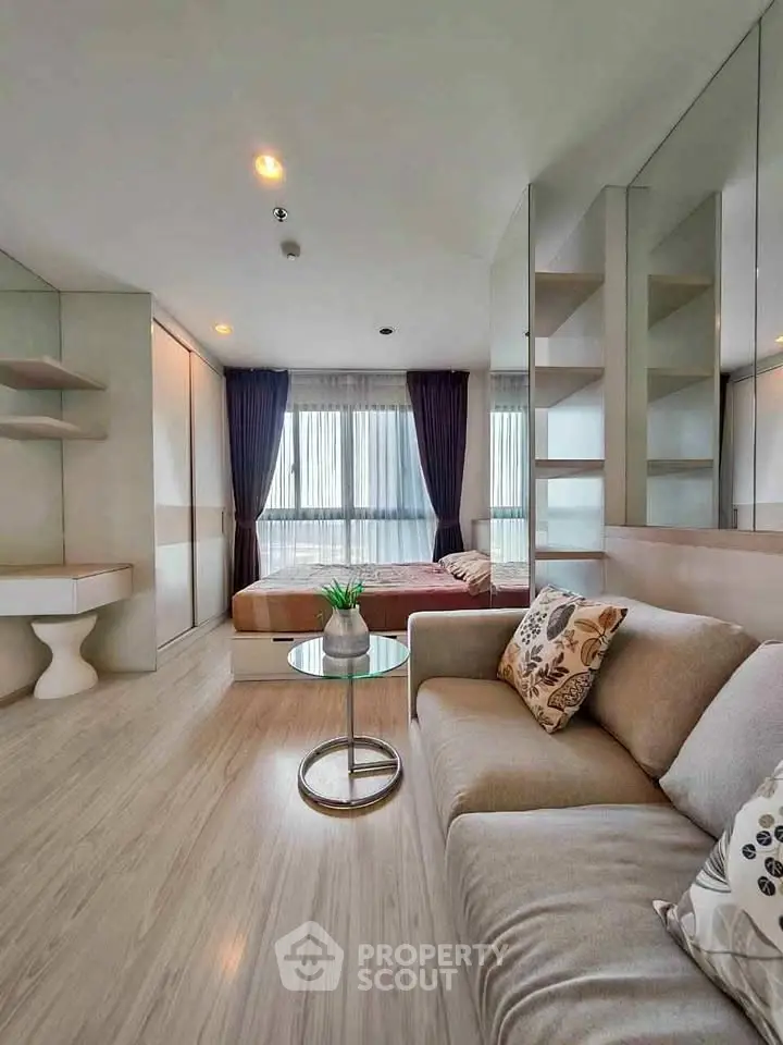 Modern living room with cozy sofa and elegant decor in a stylish apartment.
