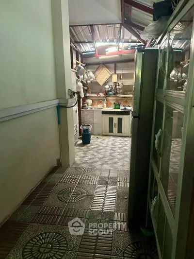 Charming rustic kitchen with tiled flooring and open shelving, perfect for cozy home cooking.