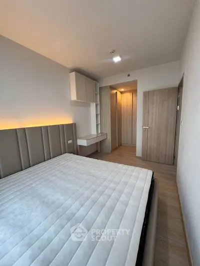 Modern bedroom with stylish furniture and ambient lighting in a contemporary apartment.