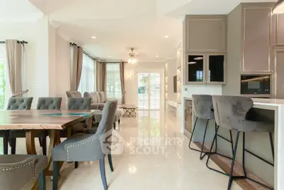 Spacious open-plan living and dining area with modern kitchen and elegant decor.