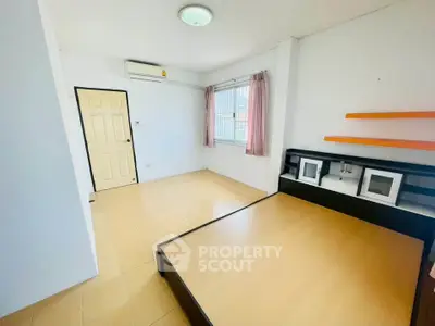 Spacious bedroom with built-in bed and natural light, ideal for comfortable living.