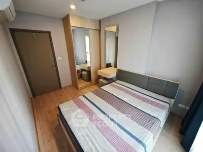 Modern bedroom with stylish decor and ample natural light, featuring a comfortable bed and sleek furnishings.