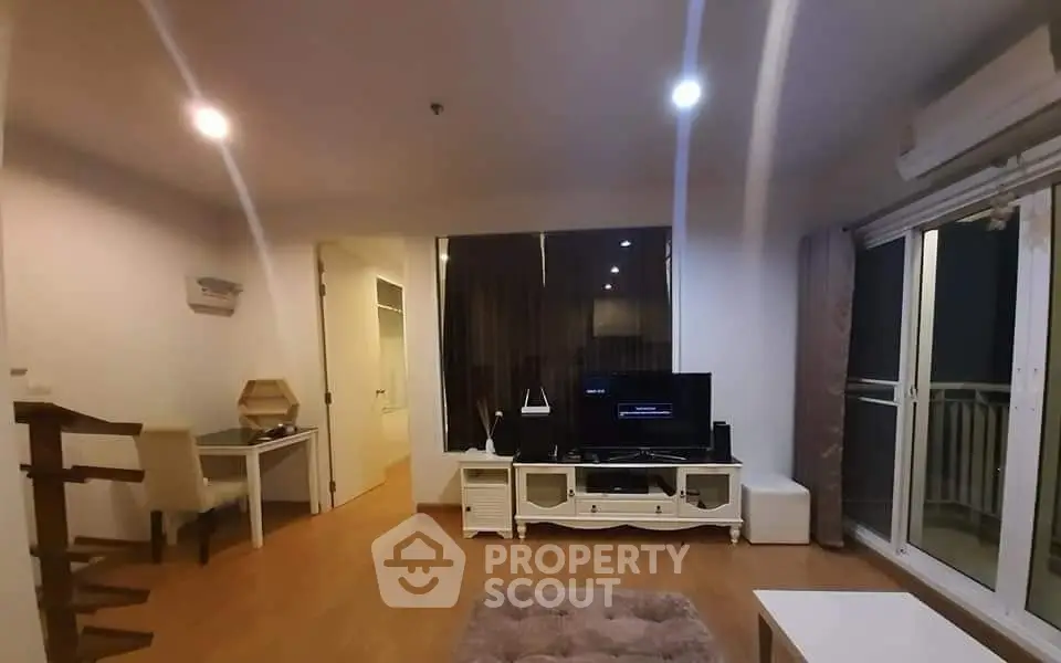 Spacious living room with modern decor and large windows for natural light.