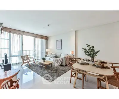 Spacious and bright living room with modern decor and dining area, perfect for relaxation and entertaining.