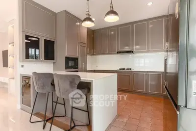 Luxurious modern kitchen with sleek cabinetry and stylish bar seating