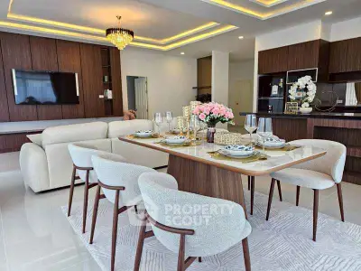 Luxurious open-plan living and dining area with elegant decor and modern furniture.