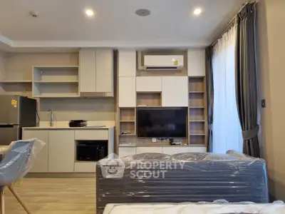 Modern living room with sleek kitchen and stylish furniture