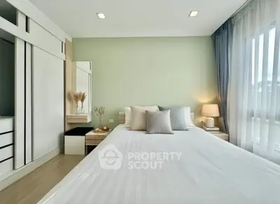 Modern bedroom with elegant decor and ample natural light