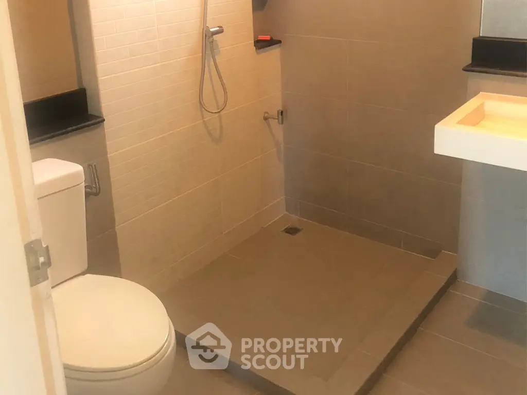 Modern bathroom with sleek shower area and contemporary fixtures.