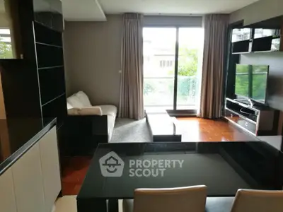 Modern living room with large window and stylish furniture, perfect for relaxation and entertainment.