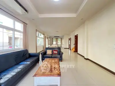 Spacious living room with natural light and modern furnishings in a stylish home.