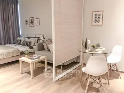 Modern studio apartment with cozy bedroom and dining area