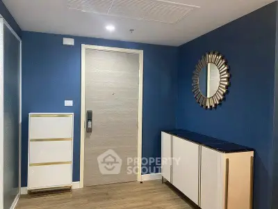 Stylish modern apartment entrance with blue walls and elegant decor