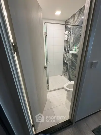 Modern bathroom with sleek shower and elegant marble tiles