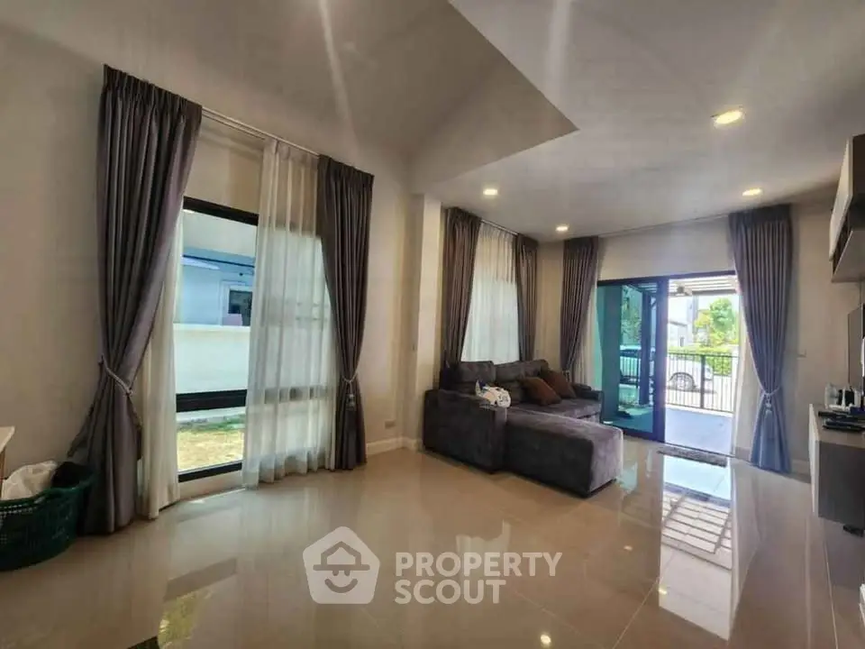 Spacious living room with modern design and large windows for natural light